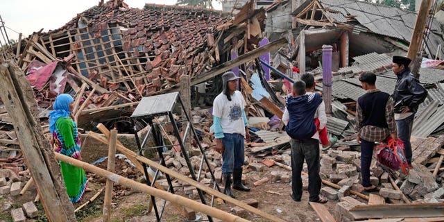 People inspect the ruins of their houses badly damaged in Monday's earthquake in Cianjur, West Java, Indonesia Tuesday, Nov. 22, 2022. 