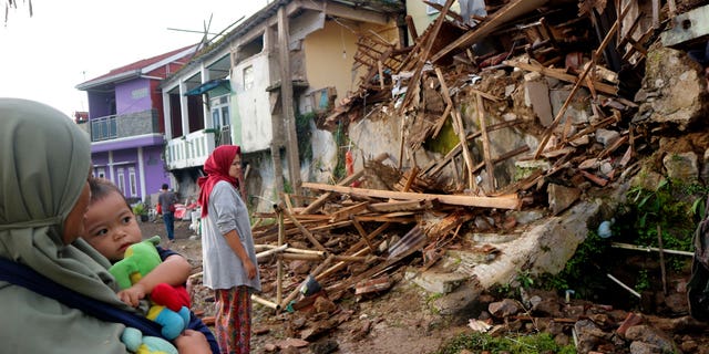 Residents inspect houses damaged by Monday's earthquake in Cianjur, West Java, Indonesia Tuesday, Nov. 22, 2022.