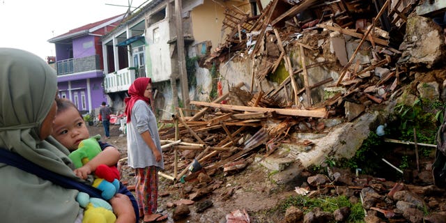 Residents inspect homes damaged by Monday's earthquake in Cianjur, West Java, Indonesia on Tuesday Nov. 22, 2022.