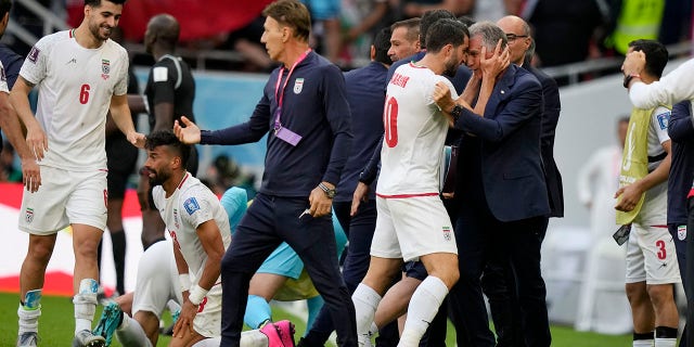 Iranian players and coaches celebrate after scoring the opening goal in extra time against Wales in Al Rayyan, Qatar on Friday 25 November 2022.