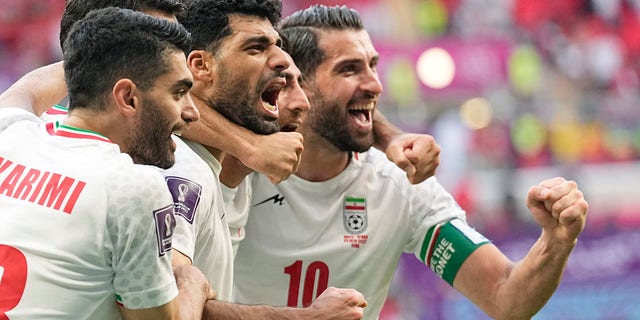 Iran's team players celebrate at the end of the World Cup Group B soccer match between Wales and Iran, at the Ahmad Bin Ali Stadium in Al Rayyan, Qatar, Friday, Nov. 25, 2022. 