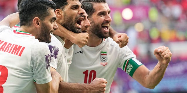 Iran's team players celebrate at the end of the World Cup Group B soccer match between Wales and Iran, at the Ahmad Bin Ali Stadium in Al Rayyan, Qatar, Friday, Nov. 25, 2022. 