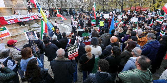 The UN office is urging Iran's government to release thousands of people who have been detained for peaceful protesting. The Human Rights Council is set to debate the situation in Iran on Nov. 24, 2022. Pictured: People hold up images and placards during a demonstration in honor of Jina Mahsa Amini and the other protesters killed under the orders of the Islamic Republic at The Place Joachim du Bellay in Paris, on Nov. 13, 2022.
