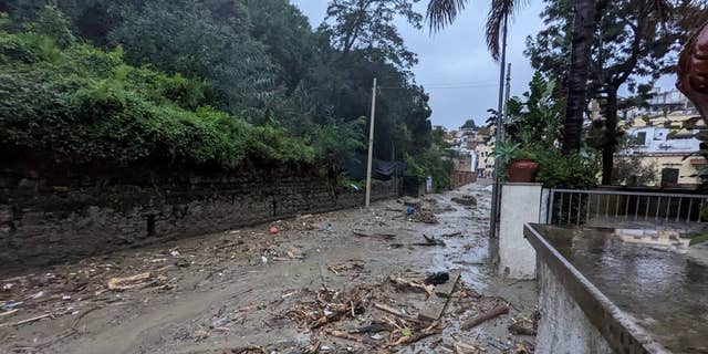 Debris are seen on the street, following a landslide on the Italian holiday island of Ischia, Italy, in this handout photo obtained by Reuters on Nov. 26, 2022.