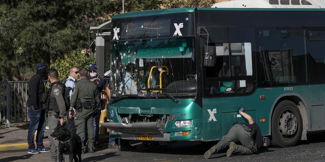 Israeli police inspect the site of an explosion at a bus stop in Jerusalem, Wednesday, November 11.  23 October 2022 Two explosions rocked bus stops in Jerusalem, killing one person and injuring at least 14 in what Israeli police say was a suspected attack by Palestinians.