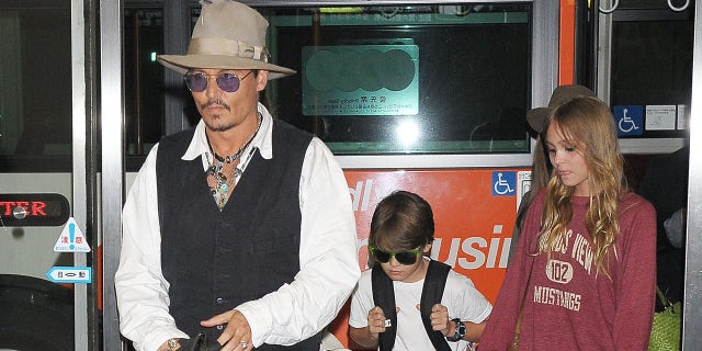 Johnny Depp, Jack Depp and Lily-Rose Depp arrive at Narita International Airport on July 16, 2013.