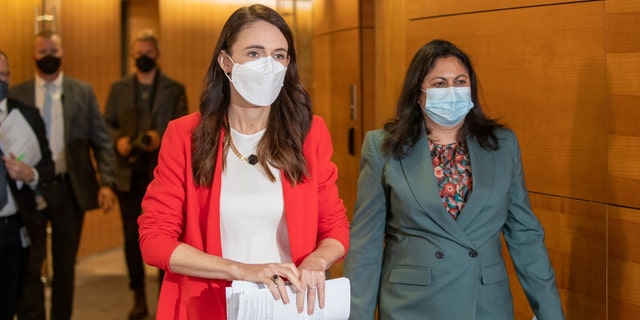 Prime Minister Jacinda Ardern, left, and Associate Health Minister Ayesha Verrall arrive ahead of their press conference at Parliament on March 23, 2022, in Wellington, New Zealand.