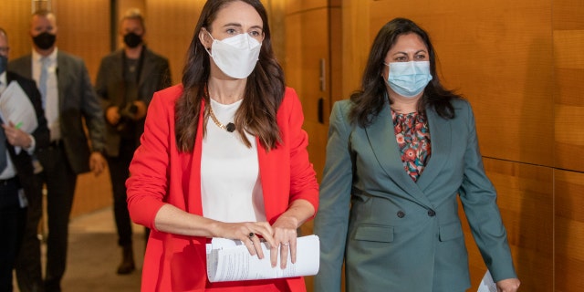 Prime Minister Jacinda Ardern, left, and Associate Health Minister Ayesha Verrall arrive ahead of their press conference at Parliament on March 23, 2022, in Wellington, New Zealand.