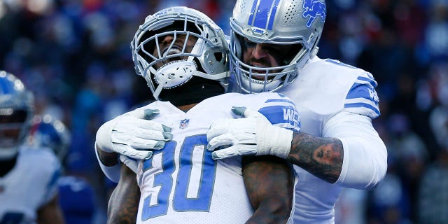 Jamal Williams (30) z Detroit Lions świętuje zdobycie przyłożenia w pierwszej połowie meczu przeciwko New York Giants 20 listopada 2022 r. w East Rutherford, NJ. 