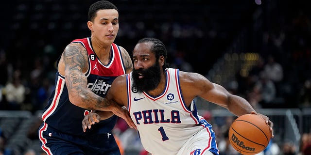 Philadelphia 76ers guard James Harden drives past Washington Wizards forward Kyle Kuzma in the second half of an NBA basketball game, Monday, Oct. 31, 2022, in Washington, D.C.