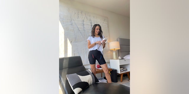 Jamie Hess is shown in her home wearing a pair of INNOVO shorts. The product is available online (myinnovo.com) and is FDA-approved.