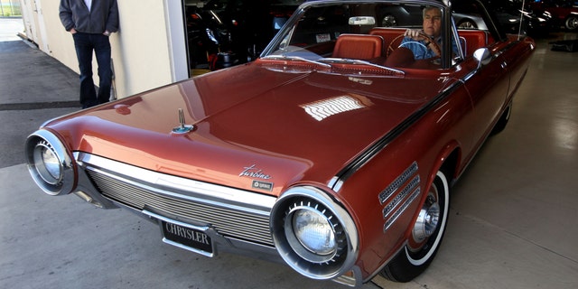 Jay Leno drives a Chrysler Turbine near Jay's Garage in Burbank. 