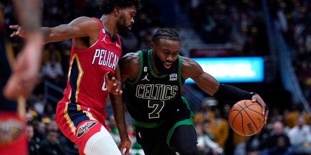 Boston Celtics guard Jaylen Brown drives to the basket against Pelicans forward Naji Marshall in New Orleans, Friday, Nov. 18, 2022.