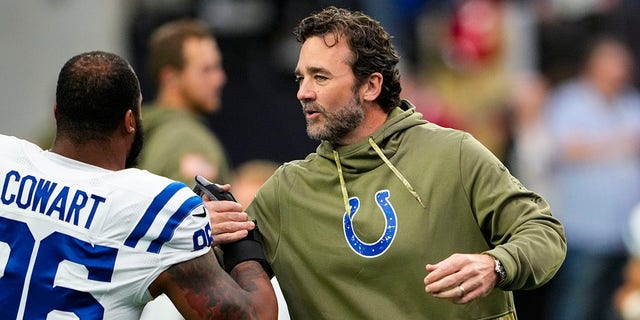 Indianapolis Colts interim head coach Jeff Saturday greets defensive tackle Byron Cowart before a game against the Las Vegas Raiders on November 13, 2022.