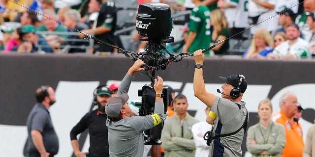 Jets brush off camera delay in upset win over Bills: 'Definitely like a conspiracy theory' 2 Workers repair a remote camera during a delay during the second half of an NFL football game between the New York Jets and the Buffalo Bills, Sunday, Nov. 6, 2022, in East Rutherford, New Jersey.
