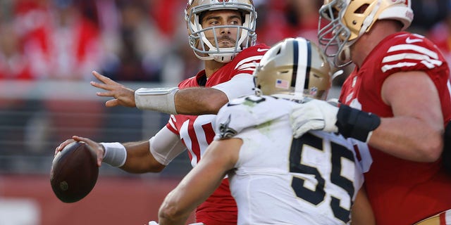 San Francisco 49ers quarterback Jimmy Garoppolo, left, passes as New Orleans Saints linebacker Kaden Elliss (55) applies pressure during the first half of an NFL football game in Santa Clara, Calif., Sunday, Nov. 27, 2022.