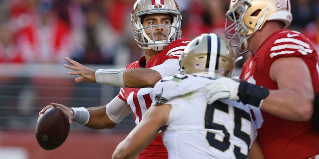 San Francisco 49ers quarterback Jimmy Garoppolo, left, passes as New Orleans Saints linebacker Kaden Elliss (55) applies pressure during the first half of an NFL football game in Santa Clara, California on Sunday, November 27, 2022.