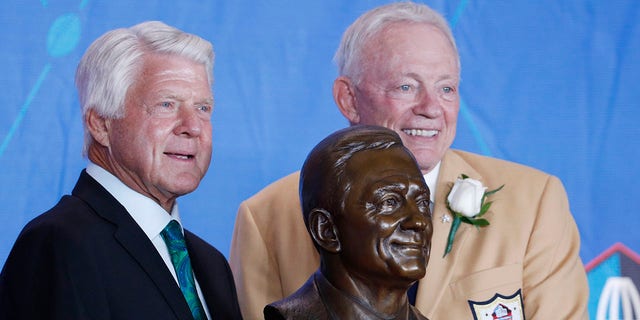 Dallas Cowboys owner Jerry Jones and presenter Jimmy Johnson pose with Jones' bust during the Pro Football Hall of Fame Enshrinement Ceremony at Tom Benson Hall of Fame Stadium on Aug. 5, 2017 in Canton, Ohio.