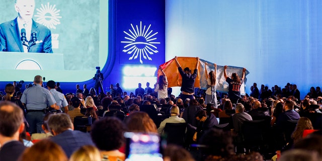 Climate activists protest as President Biden delivers a speech at the COP27 climate summit.