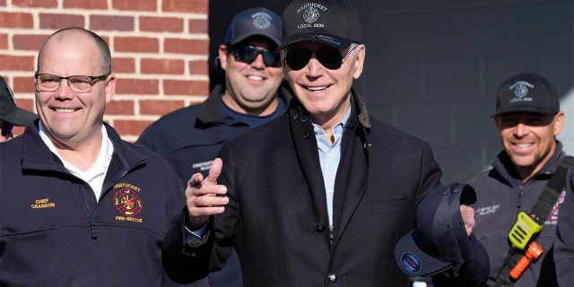 President Biden, standing next to Nantucket Fire Department Chief Michael Cranson, left, talks during a visit with firefighters on Thanksgiving Day at the Nantucket Fire Department in Nantucket, Massachusetts, Thursday, Nov. 24, 2022.