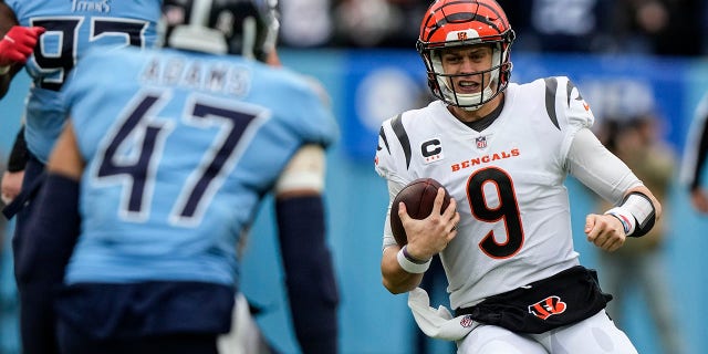 Cincinnati Bengals quarterback Joe Burrow (9) carries the ball against the Tennessee Titans during the first half on November 27, 2022 in Nashville, Tennessee.