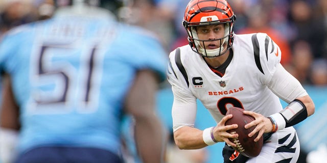 Cincinnati Bengals quarterback Joe Burrow, #9, looks for a chance to pass as they face the Tennessee Titans during the second quarter at Nissan Stadium in Nashville, Tennessee on November 27, 2022.