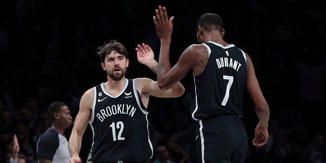 Brooklyn Nets forward Joe Harris, #12, celebrates with forward Kevin Durant, #7, after hitting a 3-point shot against the Chicago Bulls during the first half of an NBA basketball game Tuesday, Nov. 1, 2022, in New York. 