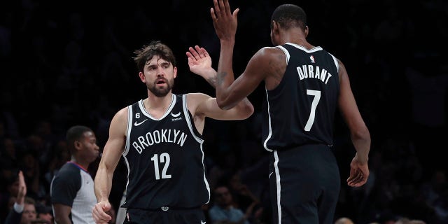 Brooklyn Nets forward Joe Harris, #12, celebrates with forward Kevin Durant, #7, after hitting a 3-point shot against the Chicago Bulls during the first half of an NBA basketball game Tuesday, Nov. 1, 2022, in New York. 