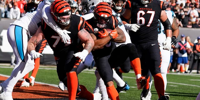 Cincinnati Bengals running back Joe Mixon, center, follows a block by offensive tackle Jonah Williams (73) into the end zone for a touchdown against the Carolina Panthers during the first half on Nov. 6, 2022, in Cincinnati.