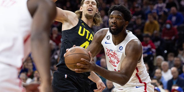 Philadelphia 76ers center Joel Embiid, #21, drives past Utah Jazz forward Kelly Olynyk, #41, during the second quarter at Wells Fargo Center in Philadelphia Nov. 13, 2022.
