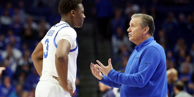 Kentucky's Adou Thiero, left, listens to coach John Calipari during the second half of the team's NCAA college basketball game against North Florida in Lexington, Kentucky, Wednesday, Nov. 23, 2022.