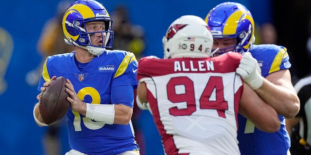 Los Angeles Rams quarterback John Wolford, left, prepares to throw during the first half of an NFL football game against the Arizona Cardinals Sunday, Nov. 13, 2022, in Inglewood, Calif. 