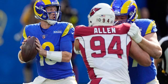 Los Angeles Rams quarterback John Wolford, left, prepares to throw during the first half of an NFL football game against the Arizona Cardinals Sunday, Nov. 13, 2022, in Inglewood, Calif.