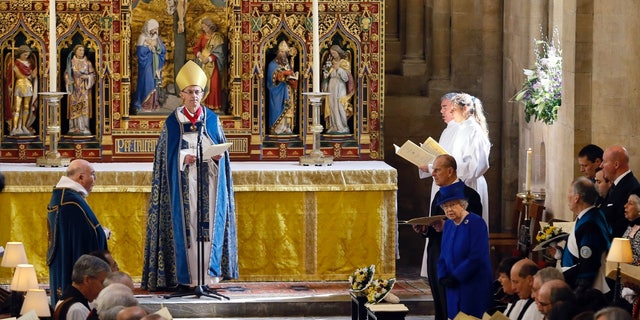 Queen Elizabeth II and Prince Phillip stand during the Maundy service conducted by the Bishop of Worcester Dr. John Inge at Christ Church Cathedral on March 28, 2013, in Oxford, England.