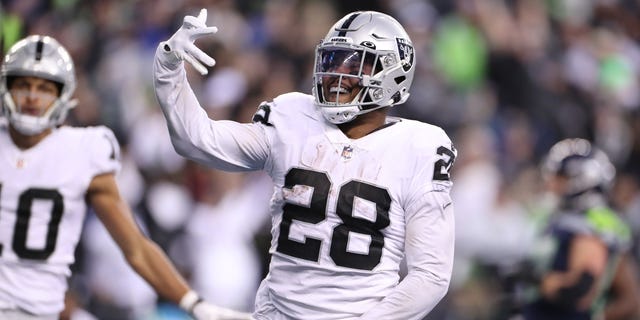 Josh Jacobs (28) of the Las Vegas Raiders celebrates after scoring a touchdown in overtime to beat the Seattle Seahawks at Lumen Field on Nov. 27, 2022, in Seattle, Washington.
