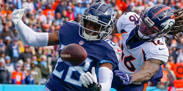Tennessee Titans safety Joshua Kalu (28) breaks up a pass intended for Denver Broncos wide receiver Tyrie Cleveland (16) during the first half of an NFL football game, Sunday, Nov. 13, 2022, in Nashville, Tenn. 