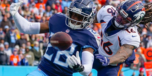 Tennessee Titans safety Joshua Kalu (28) breaks up a pass intended for Denver Broncos wide receiver Tyrie Cleveland (16) during the first half of an NFL football game, Sunday, Nov. 13, 2022, in Nashville, Tenn.