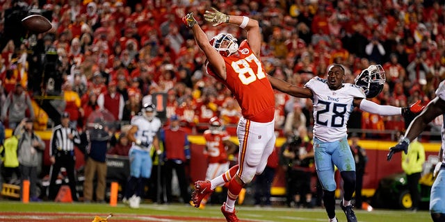 Kansas City Chiefs tight end Travis Kelce (87) is unable to catch a pass on a 2-point conversion try as Tennessee Titans safety Joshua Kalu (28) defends during the second half of an NFL football game Sunday, Nov. 6, 2022, in Kansas City, Mo. A penalty was called against the Titans on the play. 