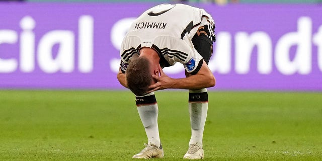 Germany's Joshua Kimmich reacts after Japan scored at the Khalifa International Stadium in Doha, Qatar, Wednesday, Nov. 23, 2022.