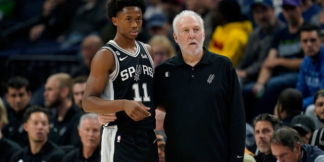 San Antonio Spurs guard Joshua Primo (11) and head coach Gregg Popovich watch play during the first half against the Minnesota Timberwolves, Oct. 24, 2022, in Minneapolis.