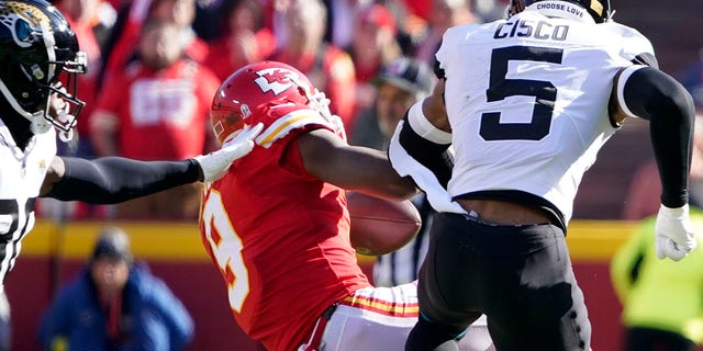 Jacksonville Jaguars safety Andre Cisco hits Chiefs wide receiver JuJu Smith-Schuster, Sunday, Nov. 13, 2022, in Kansas City.