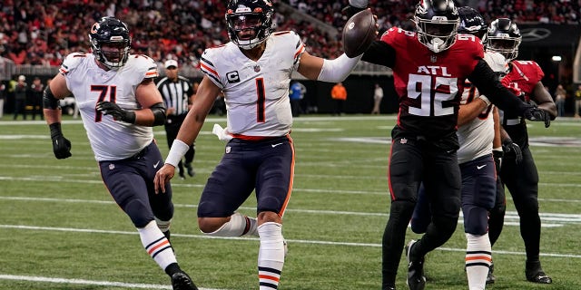 Chicago Bears quarterback Justin Fields (1) runs into the end zone for a touchdown against the Atlanta Falcons during the first half of an NFL football game, Sunday, Nov. 20, 2022, in Atlanta.