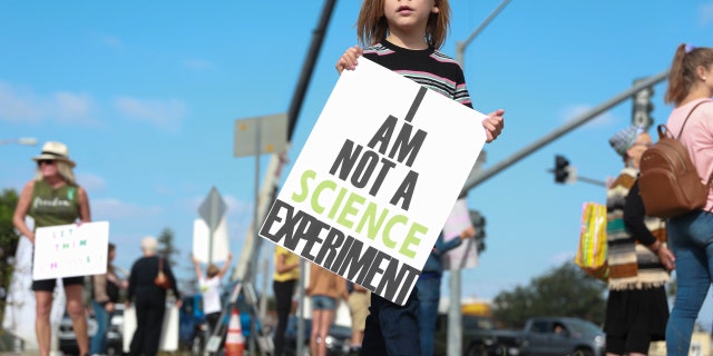 Protesters demonstrate outside the San Diego Unified School District office to protest a forced vaccination mandate for students on Sept. 28, 2021, in San Diego, California.