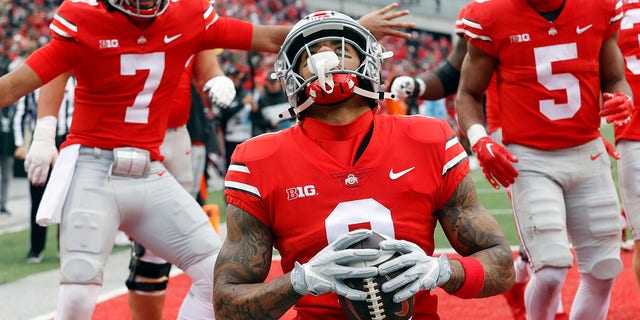 Ohio State wide receiver Kamryn Babb, center, celebrates his touchdown against Indiana with teammates quarterback C.J. Stroud, left, and running back Dallan Hayden during the second half of an NCAA college football game Saturday, Nov. 12, 2022 in Columbus, Ohio. Ohio State won 56-14. 