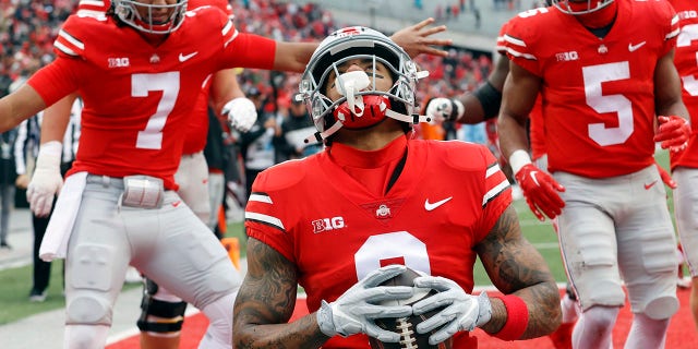 Ohio State wide receiver Kamryn Babb, center, celebrates his touchdown against Indiana with teammates quarterback C.J. Stroud, left, and running back Dallan Hayden during the second half of an NCAA college football game Saturday, Nov. 12, 2022 in Columbus, Ohio. Ohio State won 56-14.