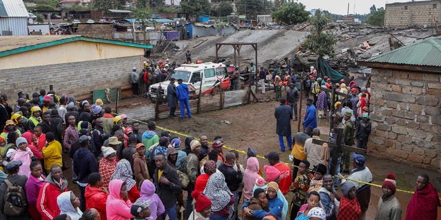 Onlookers gather at the scene of a building collapse in Ruaka, on the outskirts of the capital Nairobi, Kenya, on Nov. 17, 2022. The collapse of the building under construction is the second such collapse in a matter of days in Nairobi, where housing is in high demand and unscrupulous developers often bypass regulations.