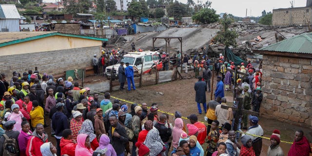 Onlookers gather at the scene of a building collapse in Ruaka, on the outskirts of the capital Nairobi, Kenya, on Nov. 17, 2022. The collapse of the building under construction is the second such collapse in a matter of days in Nairobi, where housing is in high demand and unscrupulous developers often bypass regulations.
