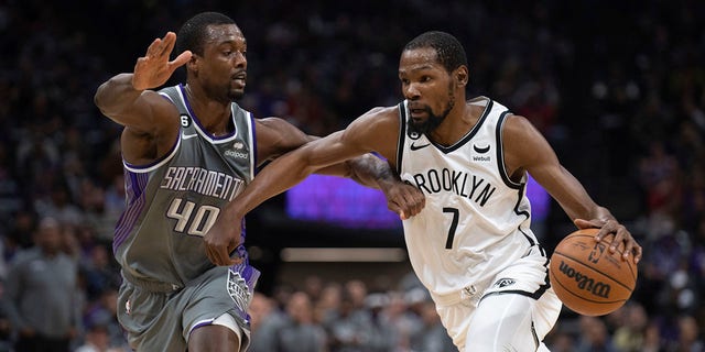 Brooklyn Nets forward Kevin Durant, #7, is defended by Sacramento Kings forward Harrison Barnes, #40, in the first quarter of an NBA basketball game in Sacramento, California, Tuesday, Nov. 15, 2022.