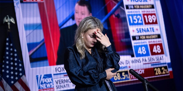 A Kevin McCarthy staff member puts her hand to her head during an Election Night watch party.