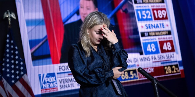 A Kevin McCarthy staff member puts her hand to her head during an Election Night watch party.